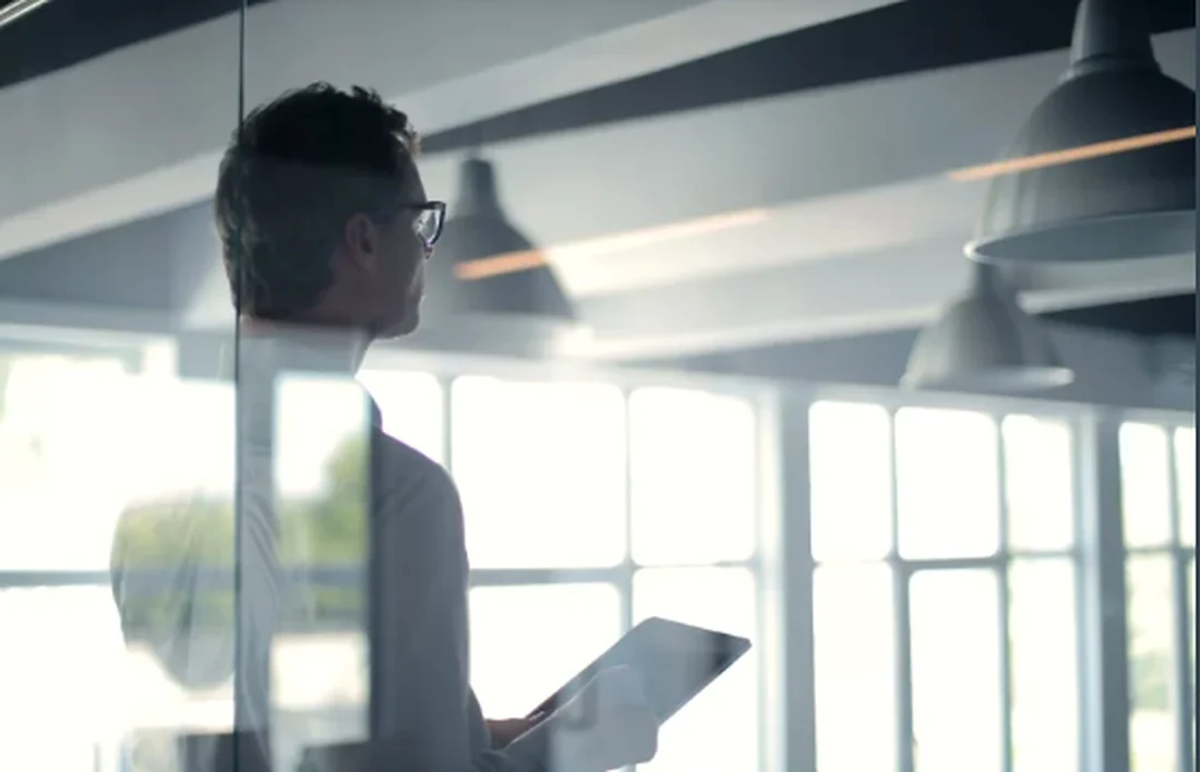 Professional reviewing plans in a modern workplace